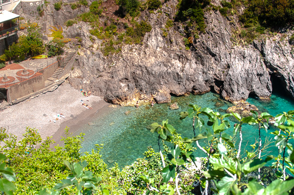 Above view of a pristine cove with crystal-clear waters along the Amalfi Coast. 