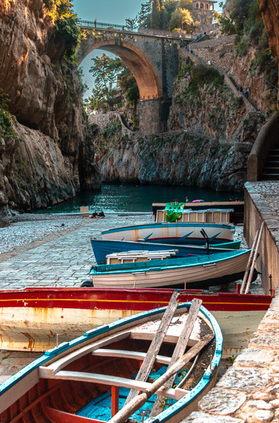 Vibrant fishing boat on the shore of The Fjord of Furore, a renowned coastal site between Amalfi and Positano. The beach under the bridge.