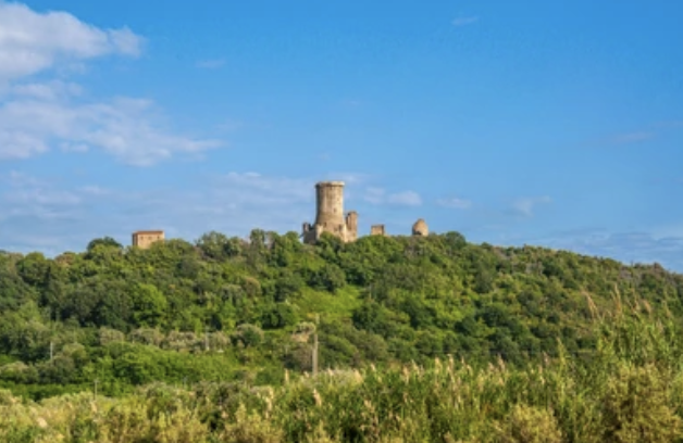 Marina di Ascea, The Archaeological park of Velia. Green hill with ancient tower on it.