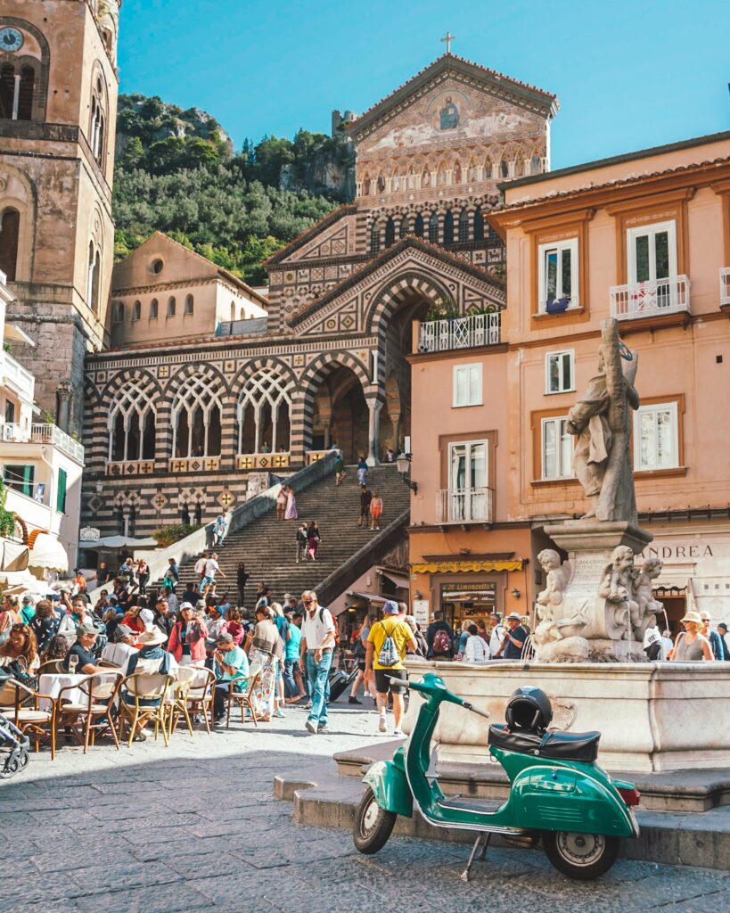 The Cathedral of Amalfi, and the main square. Green vespa parking in the foreground.