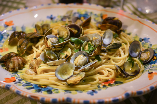 Seafood dish served in the Restarant La Botte. The image features a close up on Spaghetti alle vongole. A pasta dish with fresh clams.