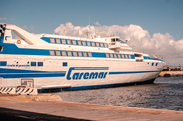 Caremar ferry in Marina Grande At Capri. Huge Ferry in the harbour, white with blue paintings.