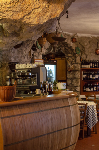 Interior of the Restaurant, wooden bar and rock off the cave.