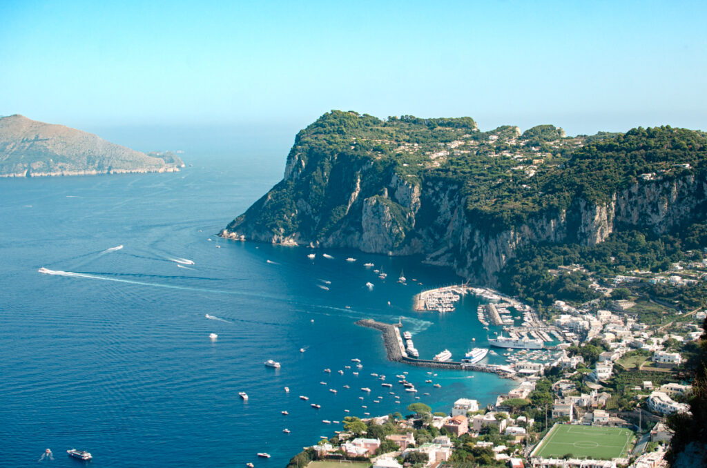The panoramic view of Capri Island, from the Terrace of Hotel San Michele. The Marina Grande harbour with numerous little boats.