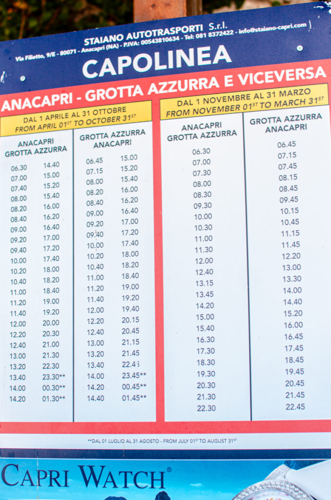 Timetable board displaying bus schedules between Anacapri and the Blue Grotto, providing information for travelers planning to reach Blu Grotto by land on Capri Island.