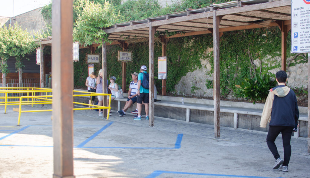 A group of people waiting at the small bus station in Anacapri for the bus bound for Grotta Azzurra / Blue Grotto.