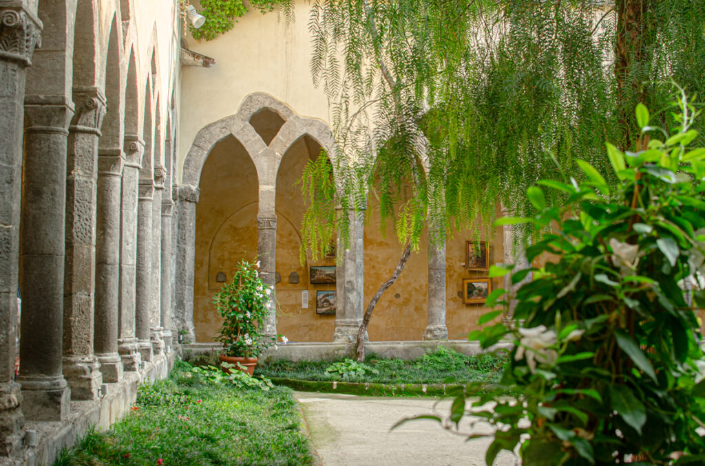 Inside the San Francesco Cloister. A very picturesque view of the archs and greenery growing in the open.