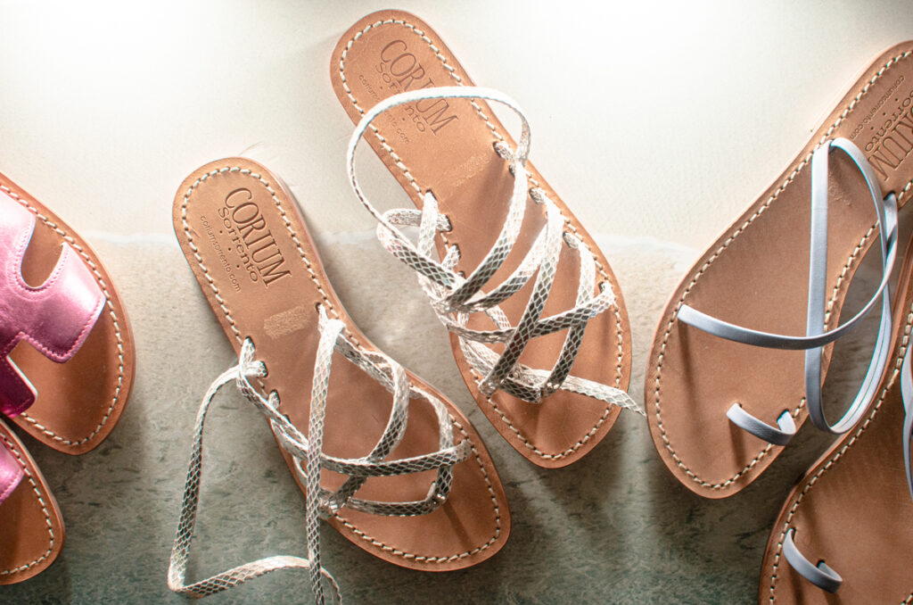 An example of a classic handmade Sorrento sandal: brown leather sole with glittery silver straps crossing each other.