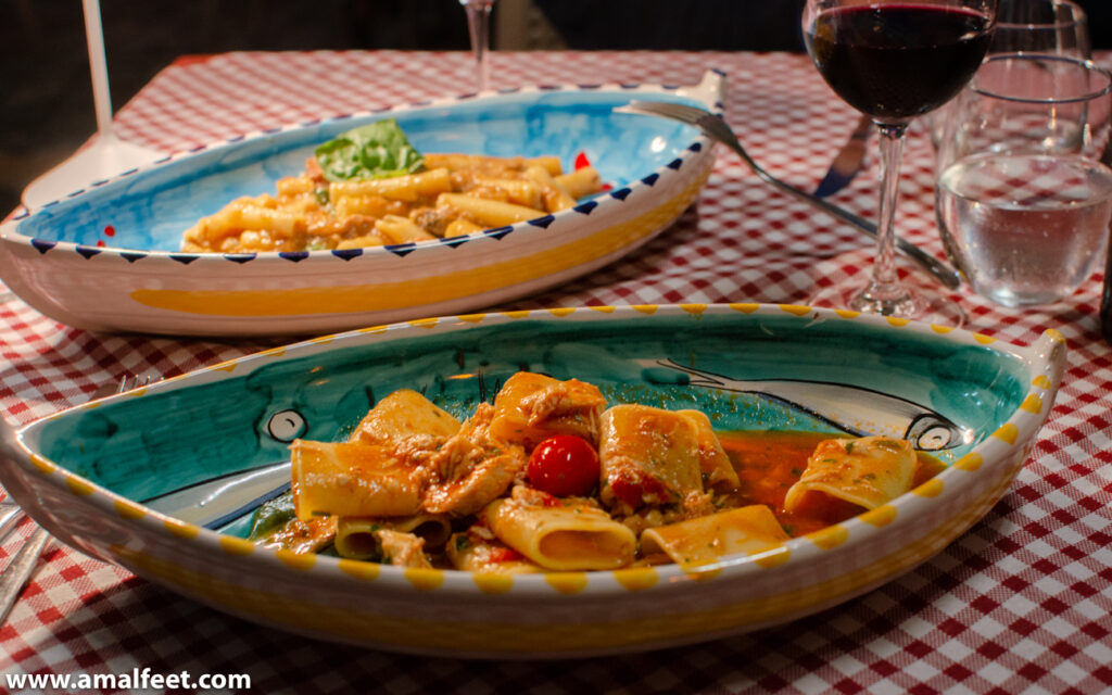 Pasta dishes at Lucia 34. The food is served in big hand painted ceramic plates. the plates are shaped like boats.