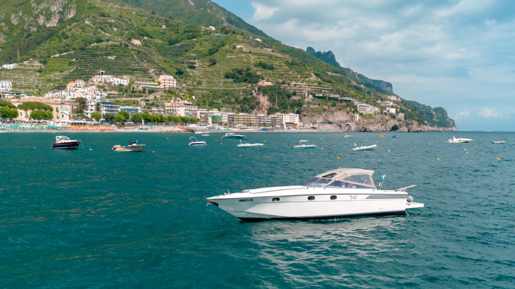 Captain Andrea's elegant and fast boat anchored in the turquoise waters near Maiori on the Amalfi Coast.